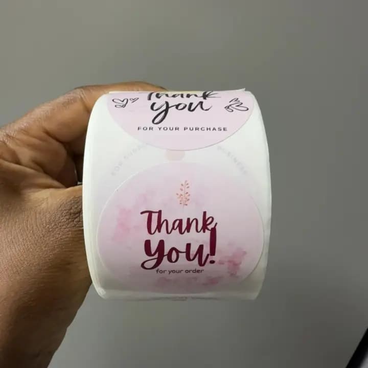 Pink "THANKYOU" stickers roll.