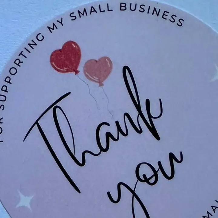 Pink "THANKYOU" stickers roll.